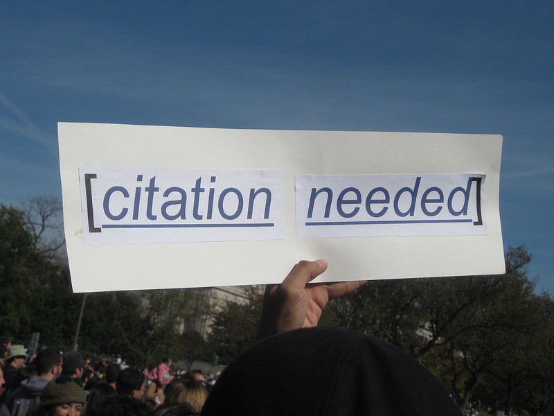 A sign that reads "citation needed" held up at a rally in Washington, DC.