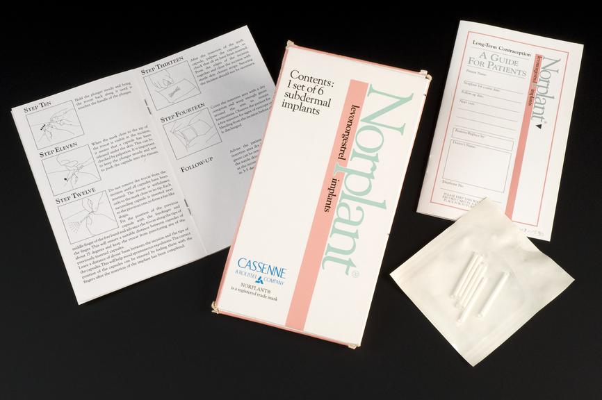 A box of Norplant branded leveonogestrel implants, with a manual placed to its left, and A Guide for Patients and the actual implants placed to the right.