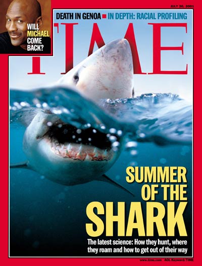 Time magazine cover prominently displaying a shark in turbulent water with its head peeking above the surface and its mouth open.