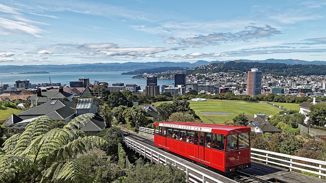 Wellington, New Zealand in the background with a red Wellington Cable Car in the foreground.